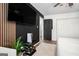 Bedroom with a large TV, wood-look flooring, and a black accent wall at 2251 Pernoshal Ct, Atlanta, GA 30338