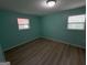 Light and airy bedroom with wood-look laminate flooring and fresh paint at 6148 Park Dr, Forest Park, GA 30297