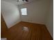 Bright bedroom features hardwood floors, neutral walls, and a window for natural light at 6148 Park Dr, Forest Park, GA 30297