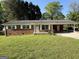 Charming brick home featuring white shutters and a covered carport at 6148 Park Dr, Forest Park, GA 30297