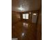 Inviting living room with hardwood floors, wood paneling, and natural light from double windows at 6148 Park Dr, Forest Park, GA 30297