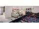 Finished basement with a foosball table, game table and bar, and two upholstered armchairs at 753 Myrica Ave, Locust Grove, GA 30248
