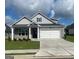 Charming one-story home featuring a gray brick facade, white garage door, and manicured lawn at 753 Myrica Ave, Locust Grove, GA 30248