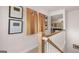 Stairway landing with charming decor, including two wooden cornhole boards and domino-themed wall art at 753 Myrica Ave, Locust Grove, GA 30248