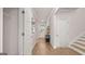 Hallway with stairway, door to front yard, and doorway to living room at 753 Myrica Ave, Locust Grove, GA 30248