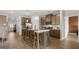 Kitchen with island and bar seating, stainless steel appliances, pendant lights and wood floors at 753 Myrica Ave, Locust Grove, GA 30248