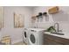 Laundry room featuring a sink, cabinetry, and modern front-loading washer and dryer at 753 Myrica Ave, Locust Grove, GA 30248