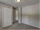 Simple bedroom with grey carpet and double-door closet at 2036 Countydown Ln, Stone Mountain, GA 30088