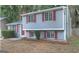 Gray sided two-story house with red shutters and a red front door at 2036 Countydown Ln, Stone Mountain, GA 30088