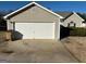 Two-car garage with a large driveway and a spacious area at 2658 Deann Dr, Ellenwood, GA 30294