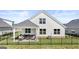 The back of the house features a covered patio with an outdoor seating area and a fenced yard at 749 Myrica Ave # 208, Locust Grove, GA 30248
