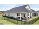 Home with a large backyard, covered patio, and privacy fence at 749 Myrica Ave # 208, Locust Grove, GA 30248