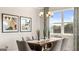 Bright dining room with large windows and a wooden table at 749 Myrica Ave # 208, Locust Grove, GA 30248