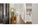 Bright entryway with dark wood console table and black front door at 749 Myrica Ave # 208, Locust Grove, GA 30248