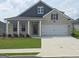 Charming brick home featuring a well-manicured lawn, covered front porch, and a two-car garage at 749 Myrica Ave # 208, Locust Grove, GA 30248