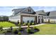 Charming home exterior with brick accents, a two-car garage, and professionally landscaped front yard at 749 Myrica Ave # 208, Locust Grove, GA 30248