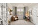 Home office with built-in shelving and a comfortable seating area at 749 Myrica Ave # 208, Locust Grove, GA 30248