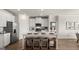 Modern kitchen with island, white cabinets, and stainless steel appliances at 749 Myrica Ave # 208, Locust Grove, GA 30248