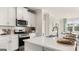 Modern kitchen with white cabinets and stainless steel appliances at 749 Myrica Ave # 208, Locust Grove, GA 30248