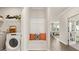 Bright laundry room with built-in bench and washer at 749 Myrica Ave # 208, Locust Grove, GA 30248
