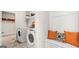 Bright laundry room features built-in shelving, a washer, and dryer at 749 Myrica Ave # 208, Locust Grove, GA 30248