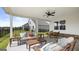 Covered patio with ceiling fan, comfortable seating, and outdoor dining at 749 Myrica Ave # 208, Locust Grove, GA 30248