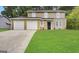 Two-story house with a two-car garage and well-manicured lawn at 3880 Springleaf Ct, Stone Mountain, GA 30083