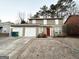 Tan two-story house with a red front door and attached garage at 3880 Springleaf Ct, Stone Mountain, GA 30083
