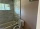 Bathroom with gray tile, a bathtub, and a toilet at 285 Queen Helen Ln, Jonesboro, GA 30236