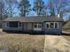 Newly painted gray house with a paved driveway and mature trees at 285 Queen Helen Ln, Jonesboro, GA 30236