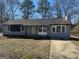 Newly painted gray house with a paved driveway and mature trees at 285 Queen Helen Ln, Jonesboro, GA 30236