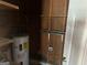 Unfinished utility room with water heater and shelving at 285 Queen Helen Ln, Jonesboro, GA 30236