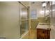 Bathroom with green tiled walls, shower/tub combo, and vanity at 155 Island Shoals Rd, Covington, GA 30016