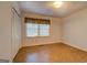 Bedroom with hardwood-like flooring, window, and double closets at 155 Island Shoals Rd, Covington, GA 30016