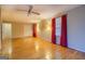 Hardwood floor bedroom with double closets and red curtains at 155 Island Shoals Rd, Covington, GA 30016