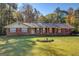 Brick ranch house with a large front yard and mature trees at 155 Island Shoals Rd, Covington, GA 30016