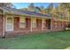 Brick house showcasing a covered porch and well-maintained landscaping at 155 Island Shoals Rd, Covington, GA 30016