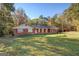 Ranch style home with a spacious lawn and wooded backdrop at 155 Island Shoals Rd, Covington, GA 30016