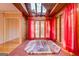 Spacious hot tub in a sunroom with skylights and red curtains at 155 Island Shoals Rd, Covington, GA 30016