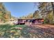 View of the back of the house and surrounding yard at 155 Island Shoals Rd, Covington, GA 30016