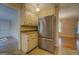 Kitchen features stainless steel refrigerator and ample cabinetry at 155 Island Shoals Rd, Covington, GA 30016