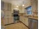 Stainless steel appliances and light wood cabinets in this kitchen at 155 Island Shoals Rd, Covington, GA 30016
