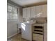 Bright laundry room with washer, dryer, and ample storage at 155 Island Shoals Rd, Covington, GA 30016
