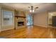 Spacious living room features hardwood floors, stone fireplace, and sliding glass doors at 155 Island Shoals Rd, Covington, GA 30016