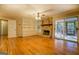 Spacious living room with hardwood floors, stone fireplace and built-in shelving at 155 Island Shoals Rd, Covington, GA 30016