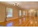 Hardwood floor living room with large windows and neutral decor at 155 Island Shoals Rd, Covington, GA 30016