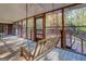 Screened porch with wooden swing and view of backyard at 155 Island Shoals Rd, Covington, GA 30016