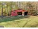Red workshop building with open doors, showing workbenches and storage at 155 Island Shoals Rd, Covington, GA 30016