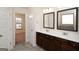 Double vanity bathroom with dark brown cabinets at 160 Traditions Ln, Hampton, GA 30228