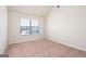 Bright bedroom with a window overlooking the backyard at 160 Traditions Ln, Hampton, GA 30228